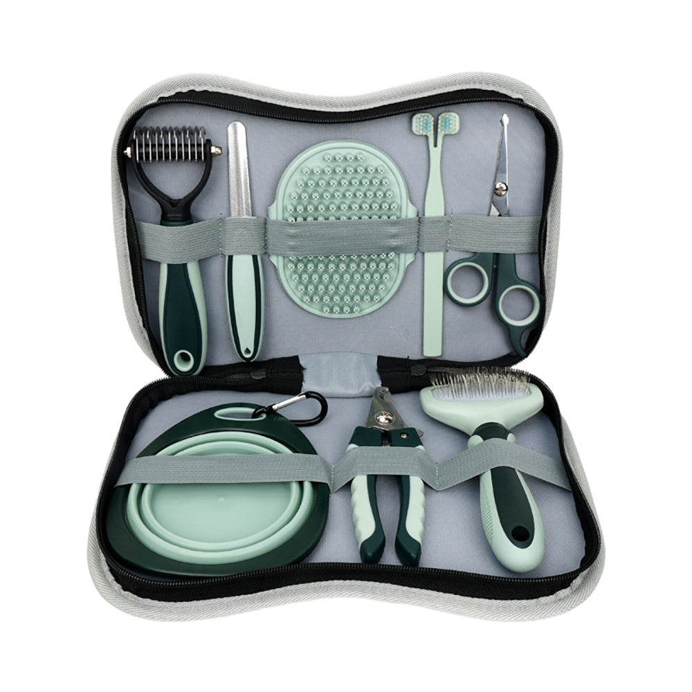 Pet grooming tool set with various tools in a case on a white background